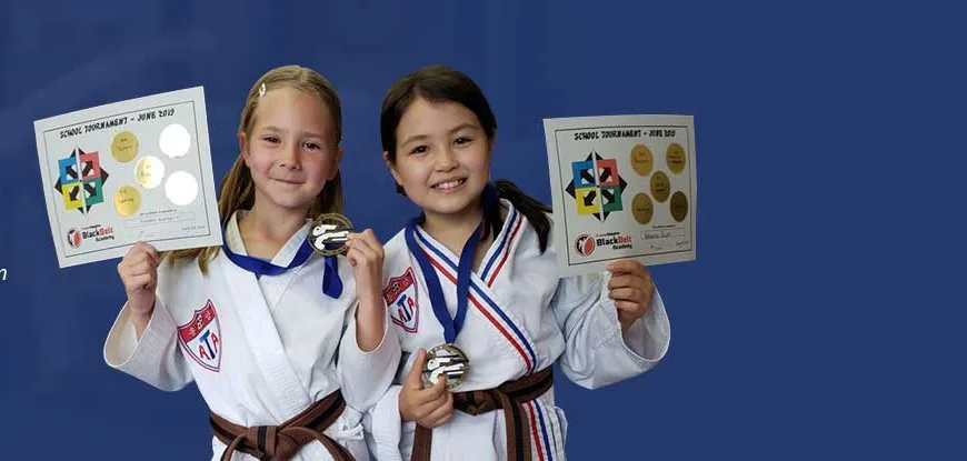 ATA TKD students holding tournament certificates, ages 8 to 12